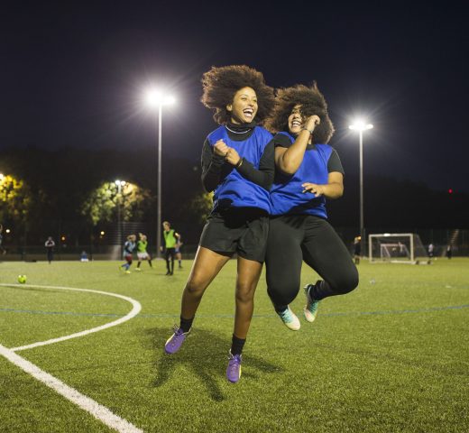 Female football players jubilant, Hackney, East London, UK