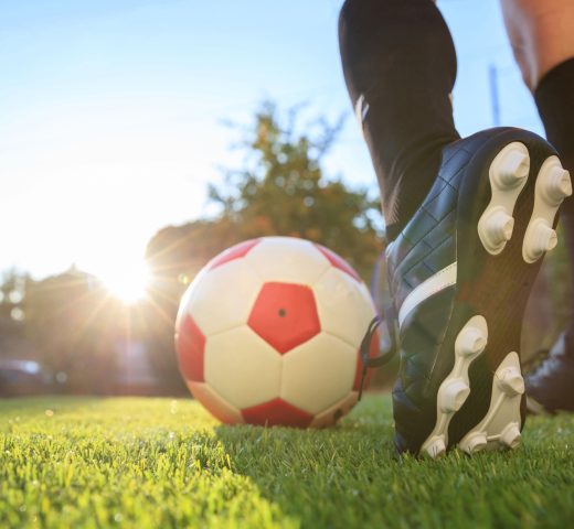 Woman and a soccer ball on the grass